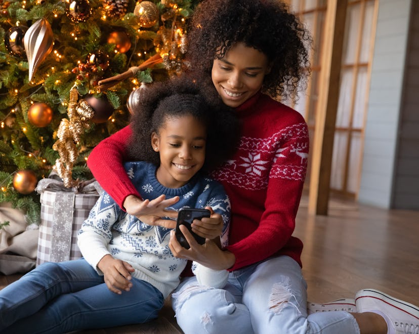 woman with her daughter looking online to find Target's 2022 Christmas Eve hours