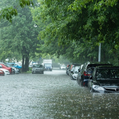 Flooded cars on the street of the city. Street after heavy rain. Water could enter the engine, trans...