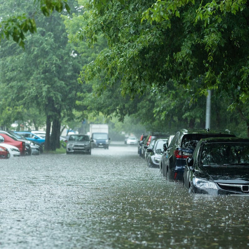 Flooded cars on the street of the city. Street after heavy rain. Water could enter the engine, trans...