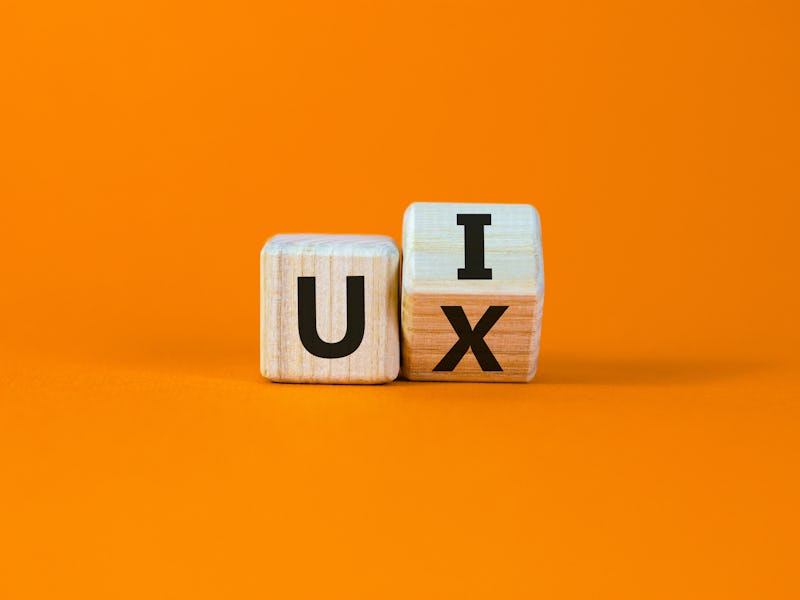 UX design or UI design. Turned cube and changed the words 'UX' to 'UI'. Beautiful orange background....