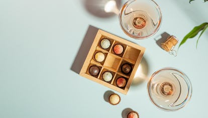 Champagne or wine in elegant glasses, a box of chocolates