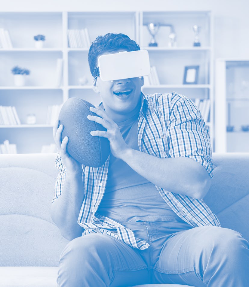 Man wearing virtual reality VR glasses watching american footbal