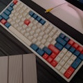 Mechanical keyboard with custom keycaps and custom made USB cable on a desk with deskmat