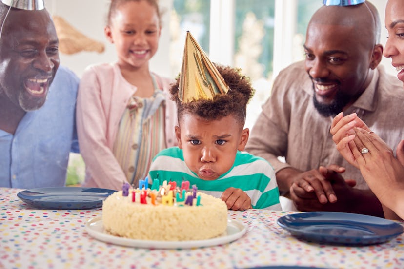Romper has feel-good instagram captions for this image of young Black boy blowing out birthday candl...