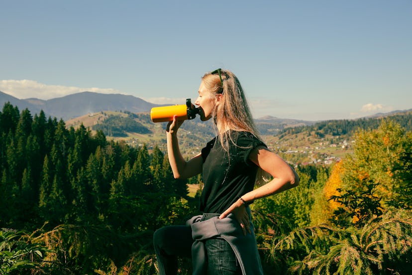 Woman drinking water during her hike