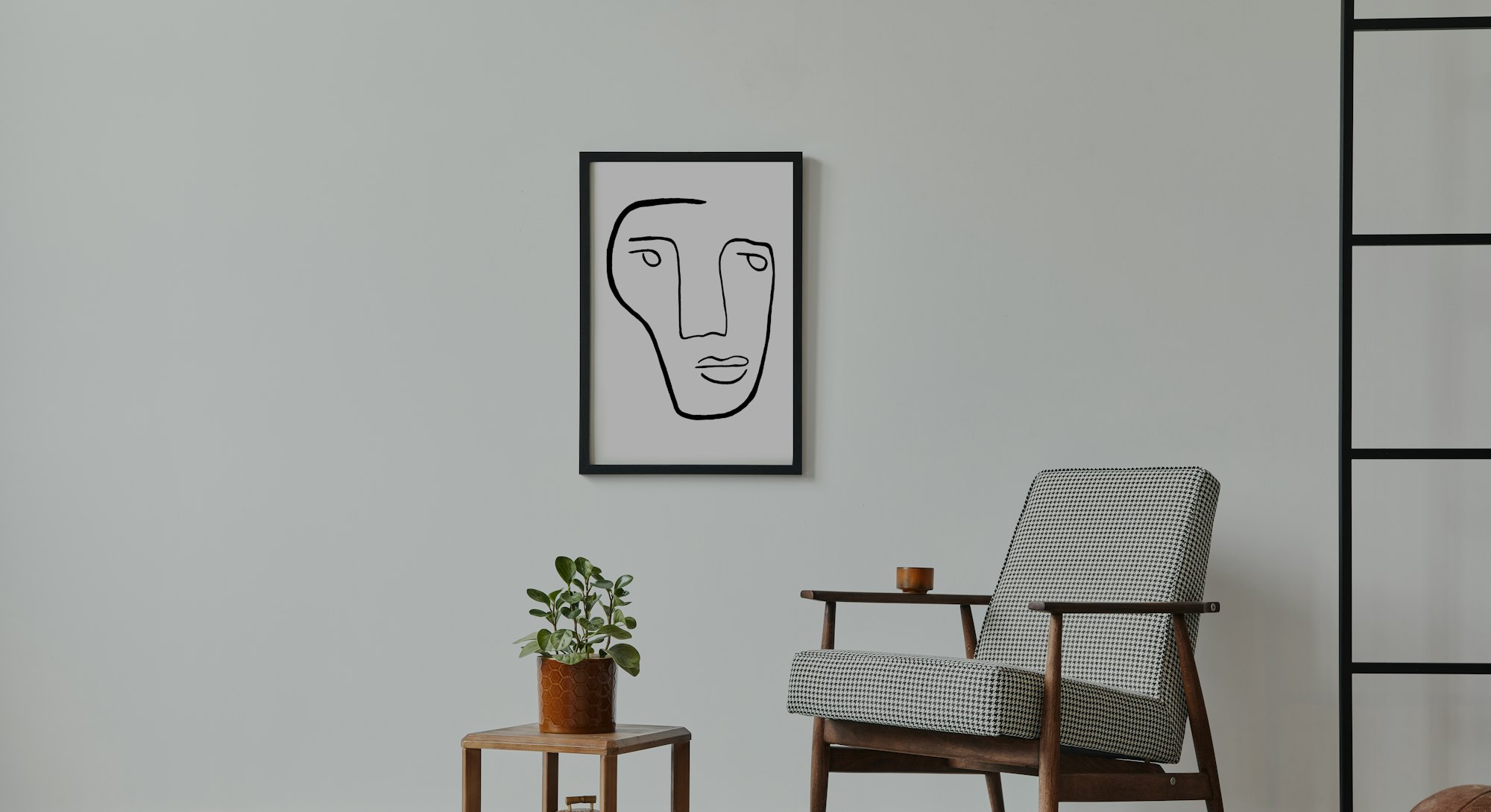 Stylish scandinavian composition of living room with design armchair, black mock up poster frame, pl...
