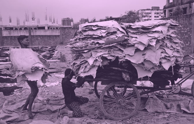 Child workers load raw dry leather on a van to shift at a wirehouse for further processing in Dhaka,...