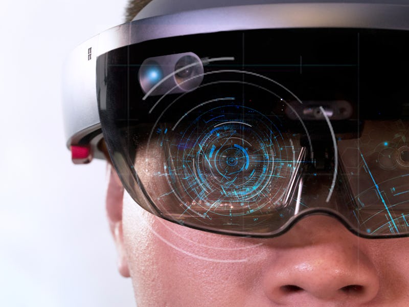 Portrait of man try Mixed reality with HoloLens glasses isolated on white background.