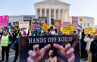 Stephen Parlato of Boulder, Colo., holds a sign that reads "Hands Off Roe!!!" as abortion rights adv...