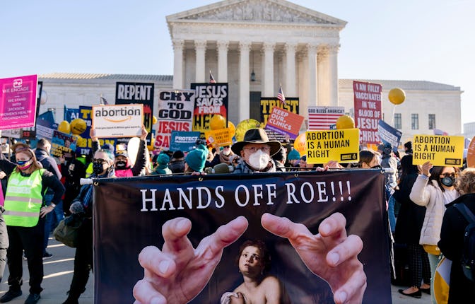 Stephen Parlato of Boulder, Colo., holds a sign that reads "Hands Off Roe!!!" as abortion rights adv...