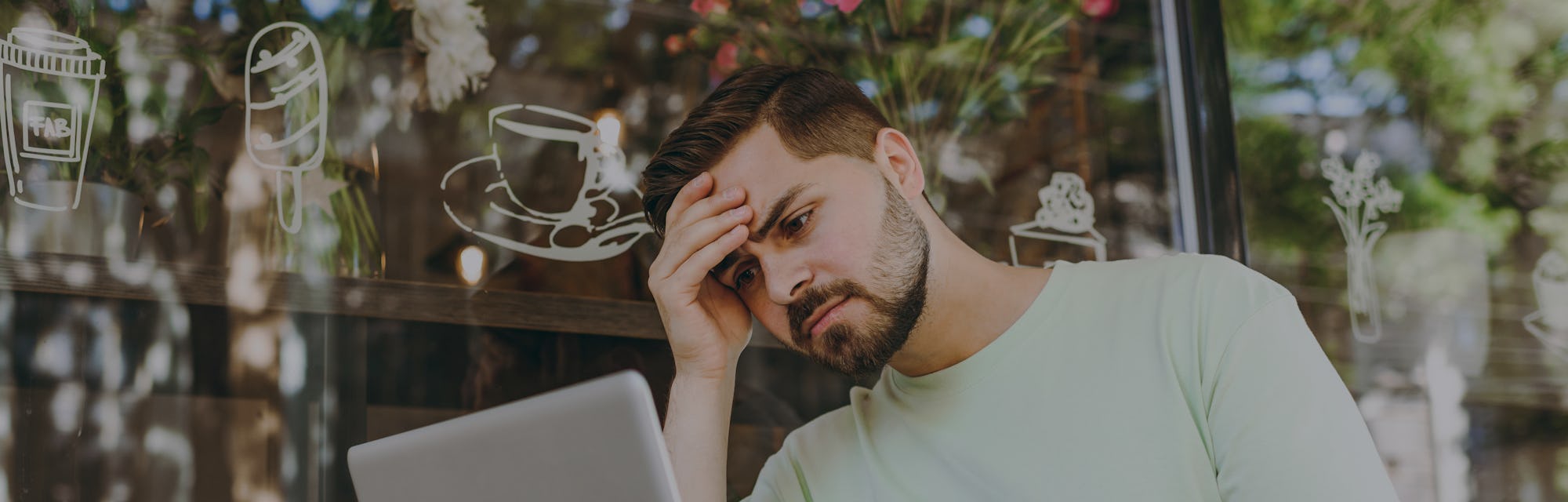 Sick tired frustrated depressed student young man in casual mint t-shirt work online with laptop pc ...