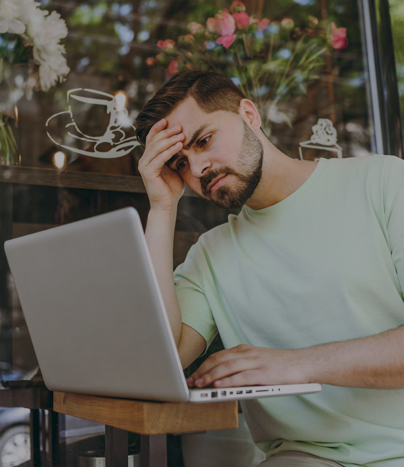 Sick tired frustrated depressed student young man in casual mint t-shirt work online with laptop pc ...