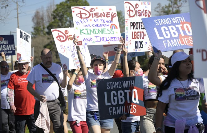 Advocates march at a rally at the Walt Disney Company in Orlando, Fla., spearheaded by advocates fro...