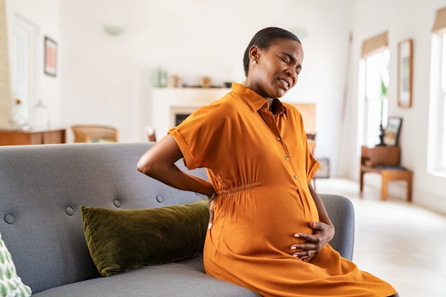 Pregnant woman has contractions, one of the signs baby is coming before due date.