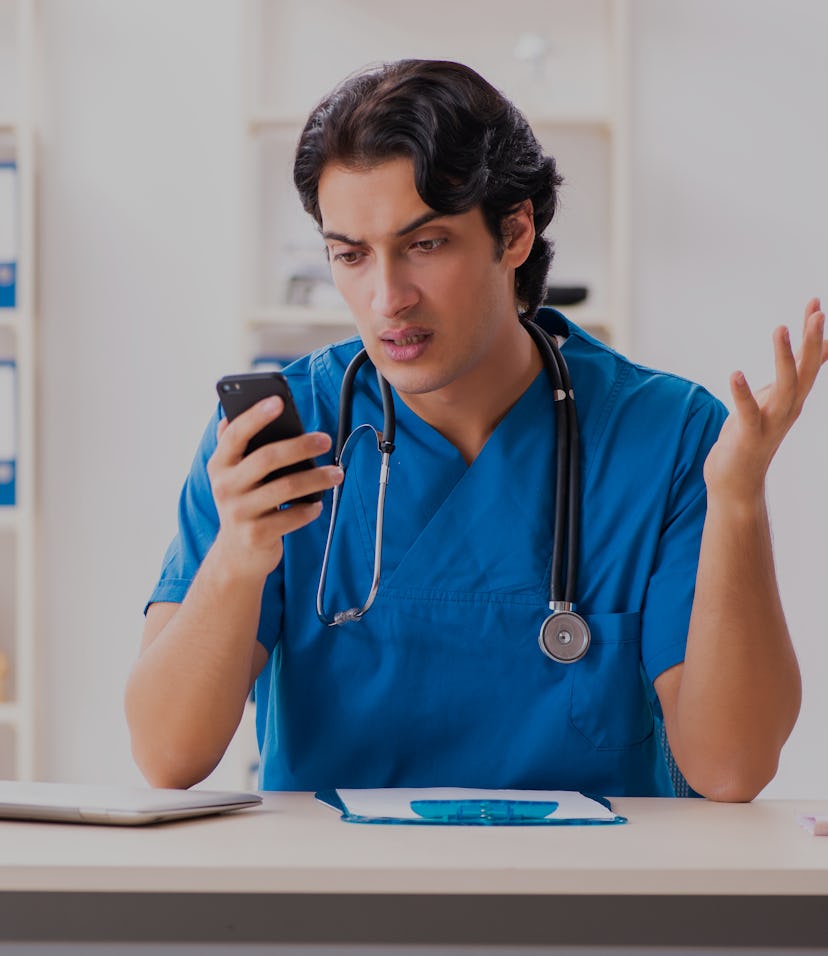 Young handsome doctor working at the clinic 