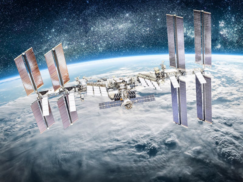International space station on orbit of Earth planet. ISS. Stars and galaxies. Elements of this imag...