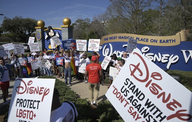 Advocates march at a rally at the Walt Disney Company in Orlando, Fla., spearheaded by advocates fro...