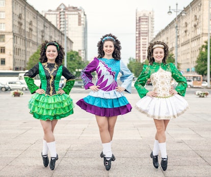 Three women in irish dance dresses posing 