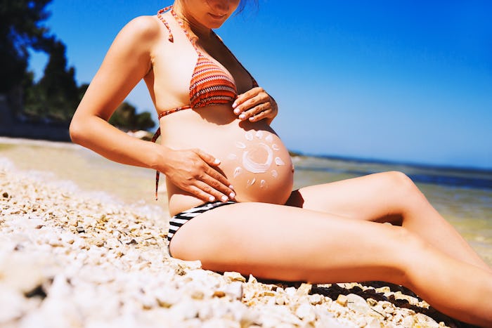 pregnant woman on beach, what you need to know about prenatal sunburn