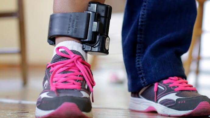 An immigrant from El Salvador that entered the country illegally wears an ankle monitor at a shelter...