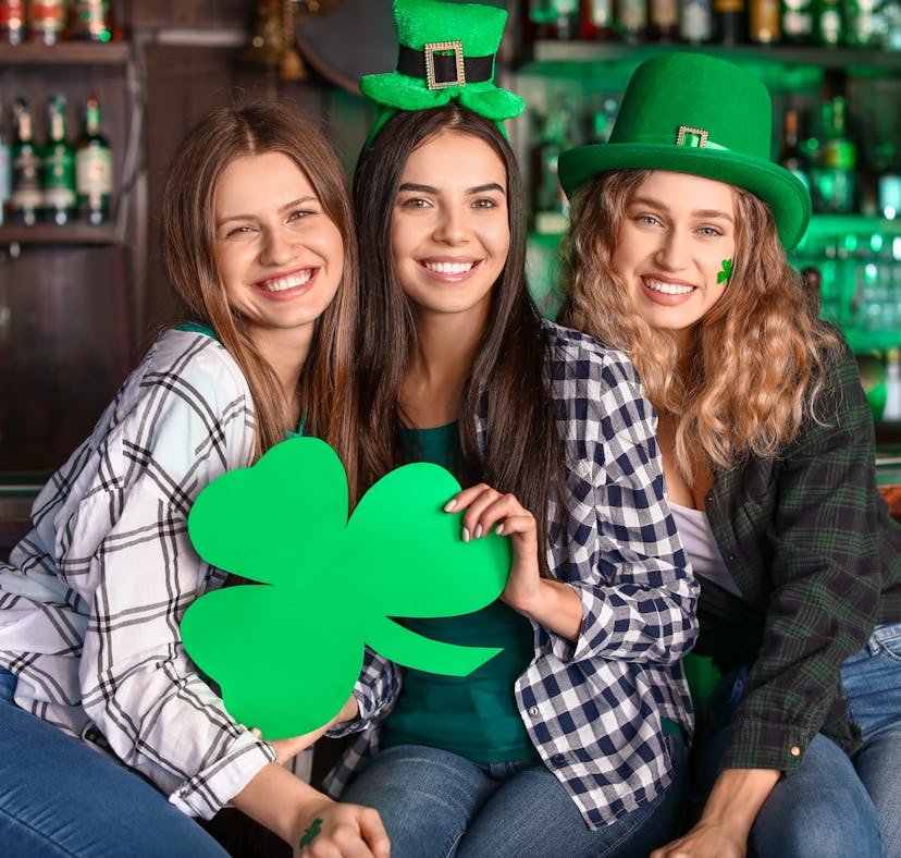 Friends having fun on Saint Patrick's day wearing funny st Patrick's day shirts.
