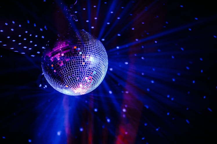 Disco ball scatters blue light in a dark room, which is the perfect vibe for a 'Euphoria' prom theme...