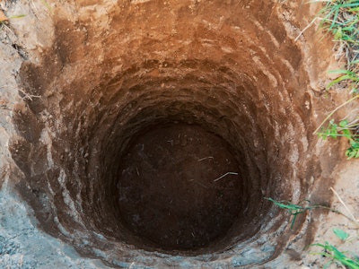 Deep pit in the ground. Digging a hole. Water Well Drilling, Dig a well for water, Groundwater hole ...