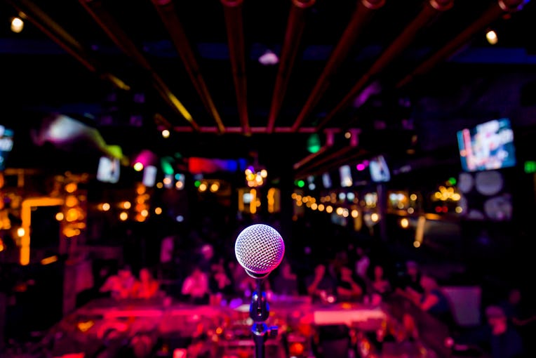 Comedy Microphone on Stage of Comedy Music Show in Club with Lights and Colors
