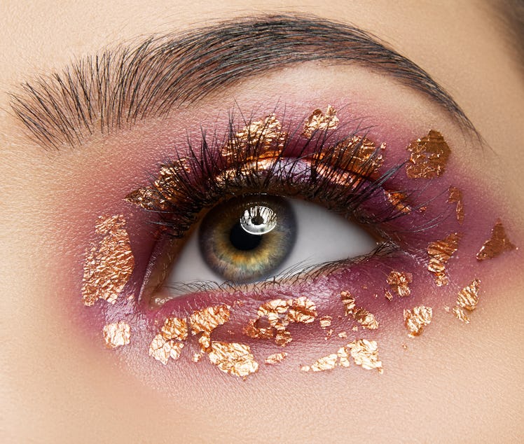 Close up of eyes with rose gold eyeshadow and gold flecks.