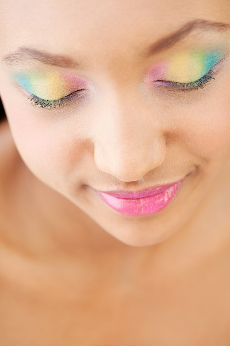 Model wearing pastel, rainbow eyeshadow.