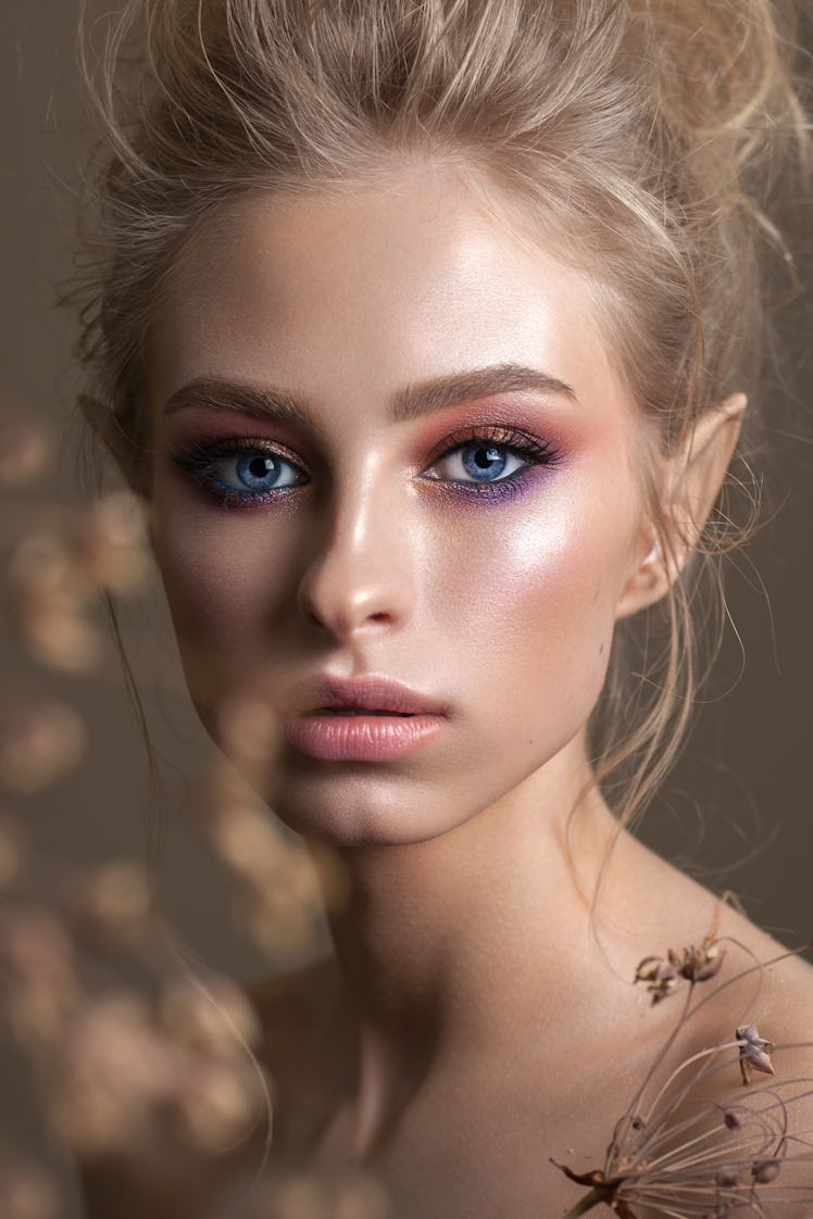 A model with smokey, rainbow eye makeup.