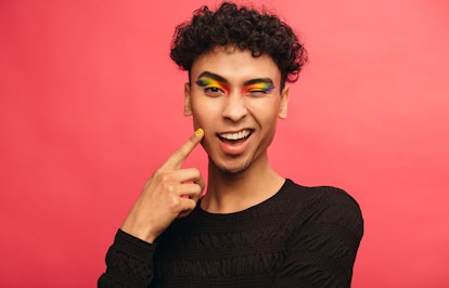Model wearing rainbow eyeshadow while winking.