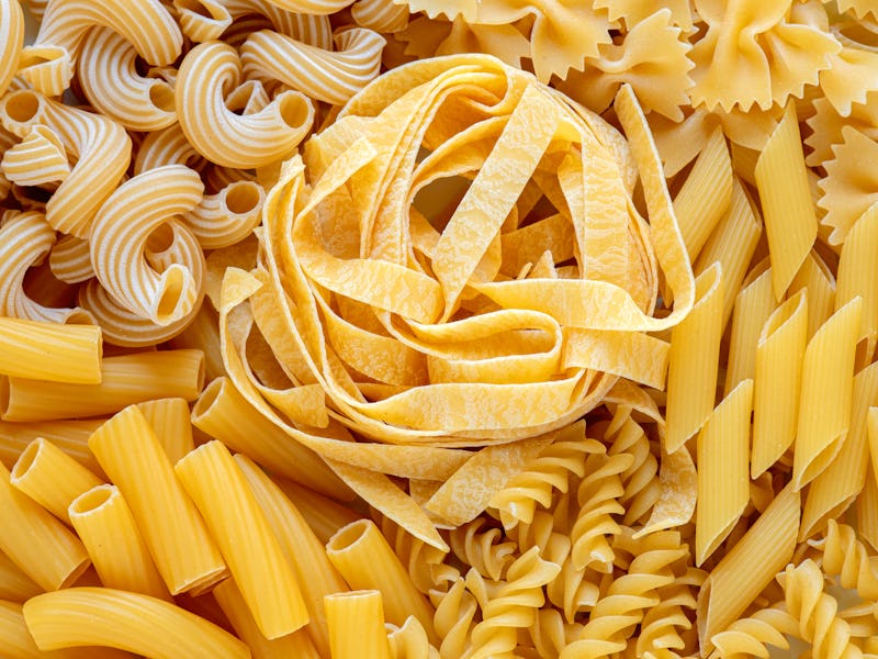 layout of Italian raw pasta, top view, different types and shapes of pasta, durum wheat noodles, clo...