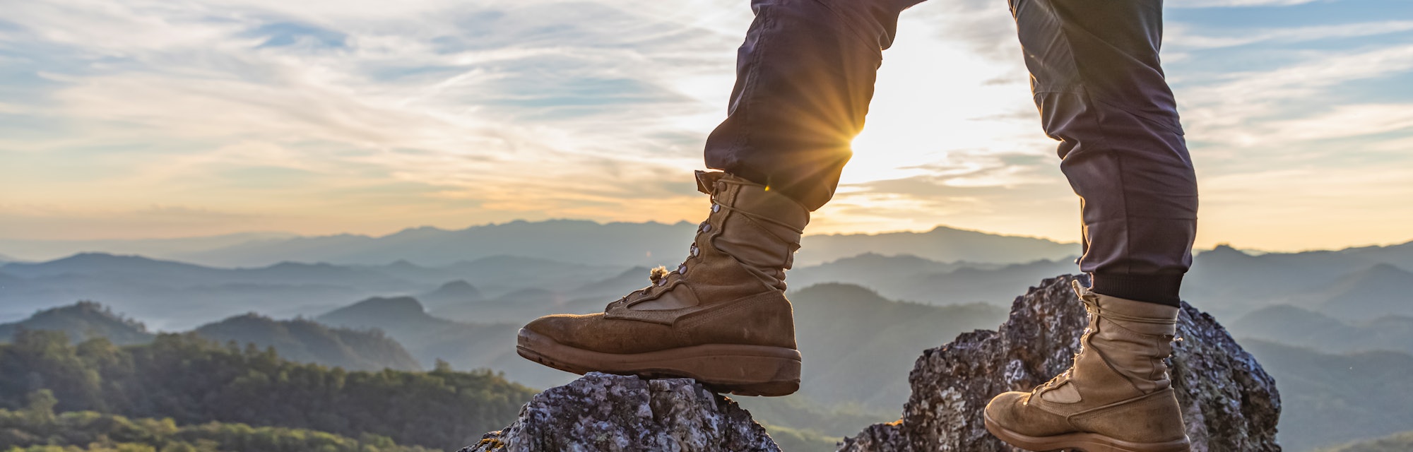 Hiker standing on top mountain sunset background. Hiker men's hiking living healthy active lifestyle...