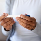 Crop close up of biracial woman hold quick pregnancy test kit check being pregnant. African American...