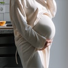 Pregnant Lady standing in diet table wearing white gown