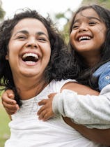 Happy indian mother having fun with her daughter outdoor