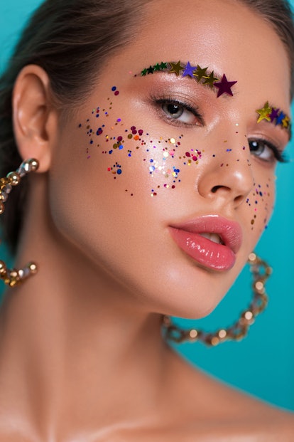 A closeup of a model wearing a lot of glitter.