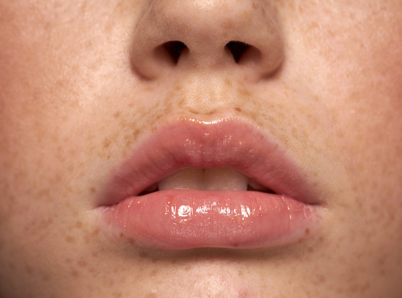 Amazing Lips young woman with Freckles Perfect Skin Closeup perfect natural lip makeup. Beautiful pl...