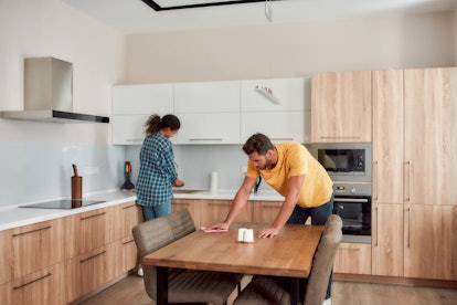 couple cleaning modern kitchen