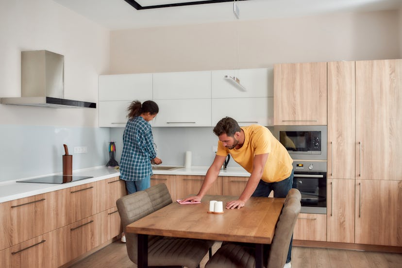 couple cleaning modern kitchen