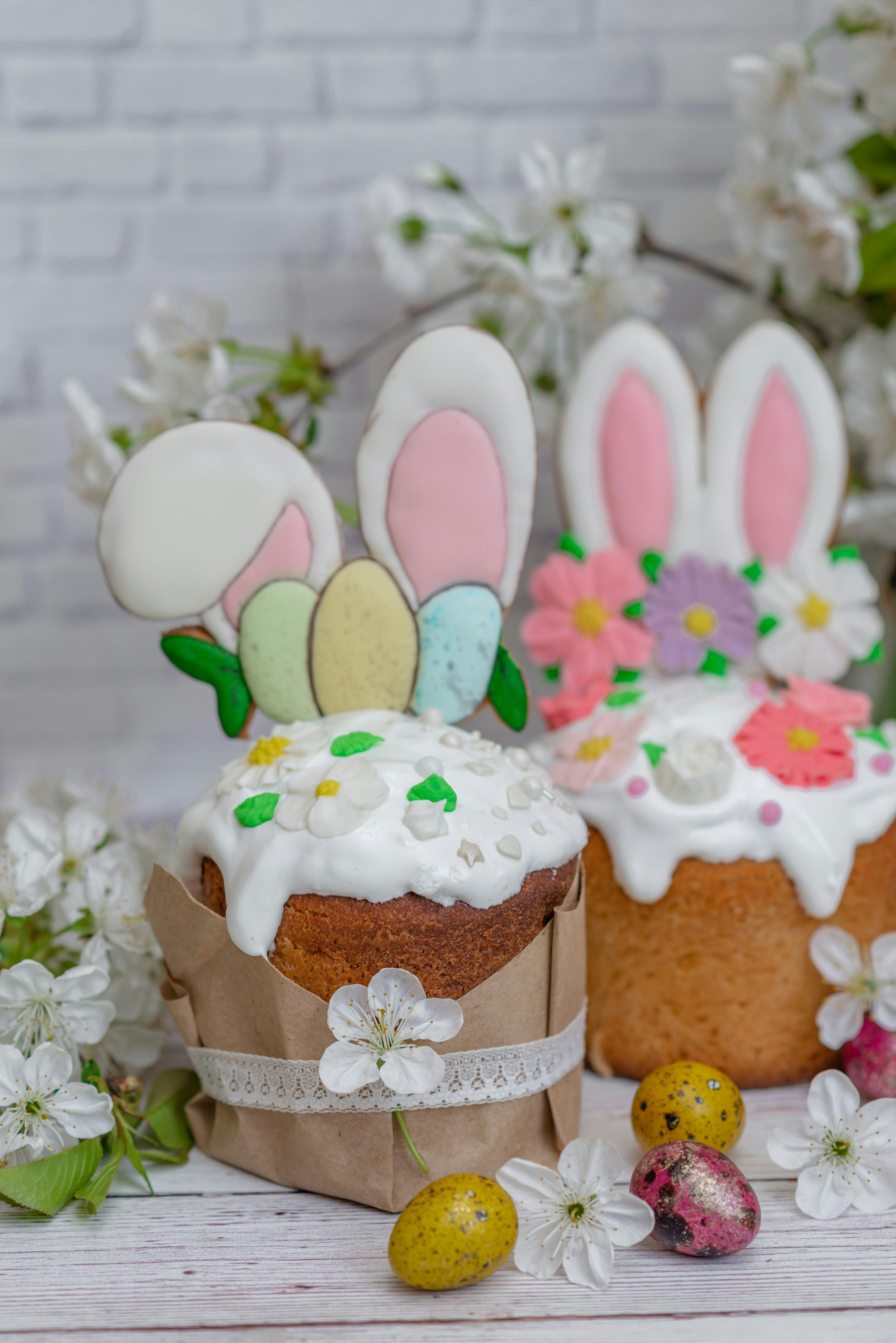 Easter cake with Easter Bunny ears and pastel eggs on top for an Easter Bunny themed dessert.