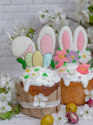 Easter cake with Easter Bunny ears and pastel eggs on top for an Easter Bunny themed dessert.