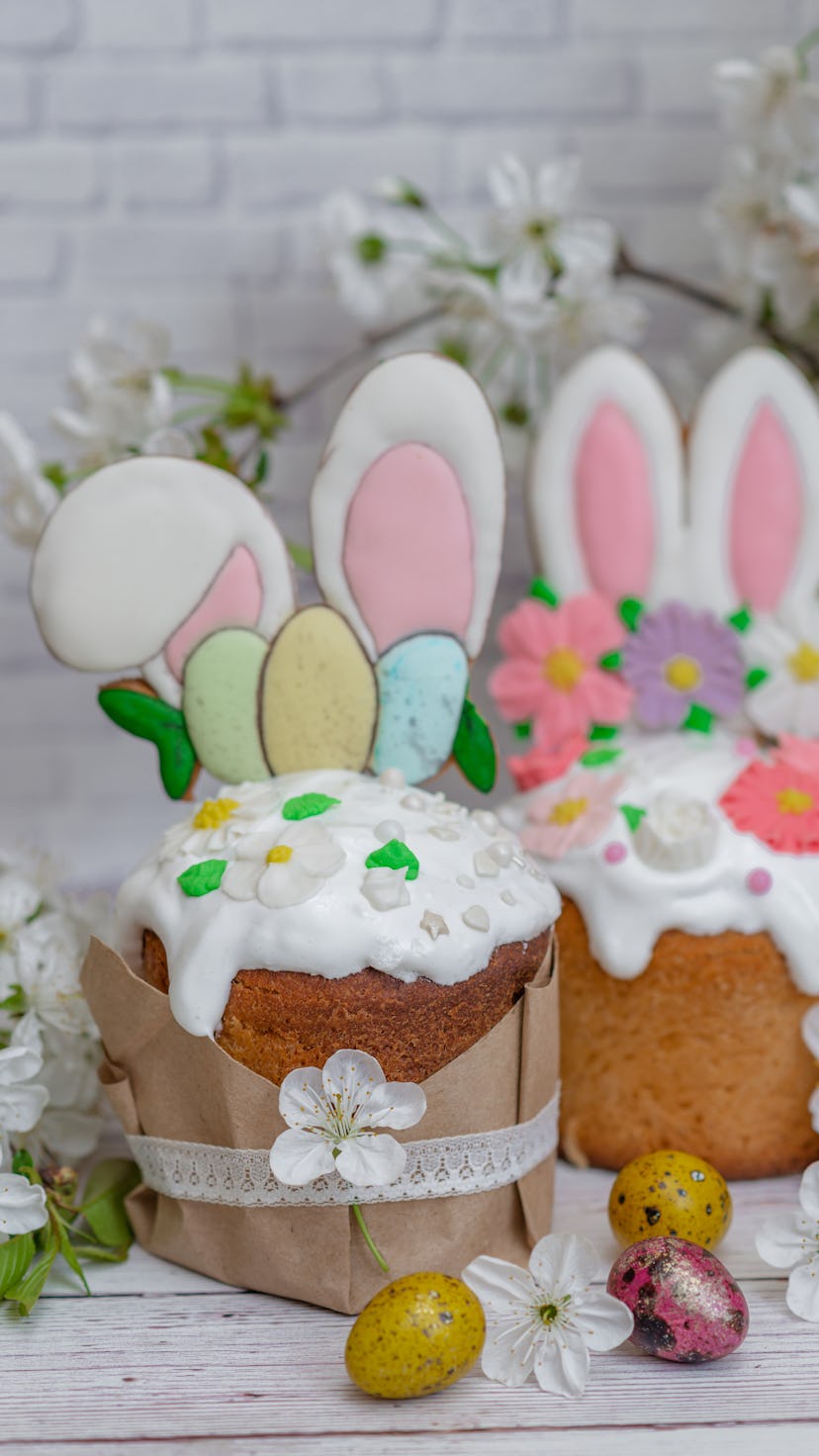 Easter cake with Easter Bunny ears and pastel eggs on top for an Easter Bunny themed dessert.
