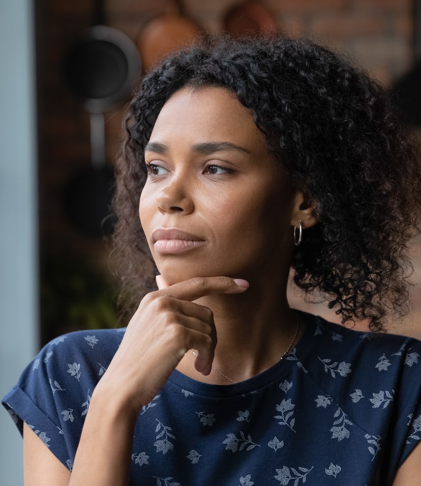 woman being thoughtful and asking herself, "am I ready to have a baby?"