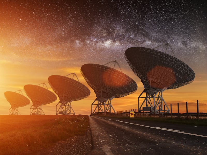 Radio Telescope view at night with milky way in the sky