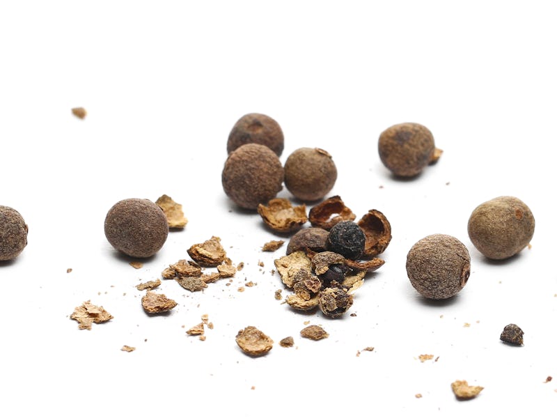 Allspice, pimento spice crushed, Jamaican pepper and shavings isolated on white background