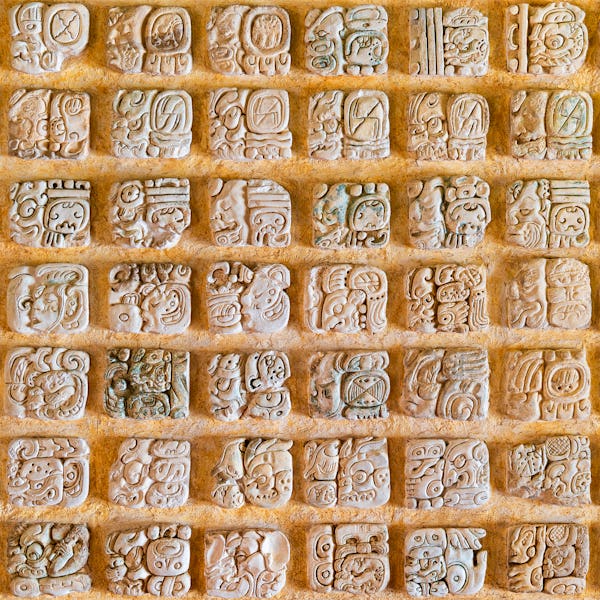 Square photograph of the Mayan alphabet. These hieroglyphs are found in the archaeological sites in ...