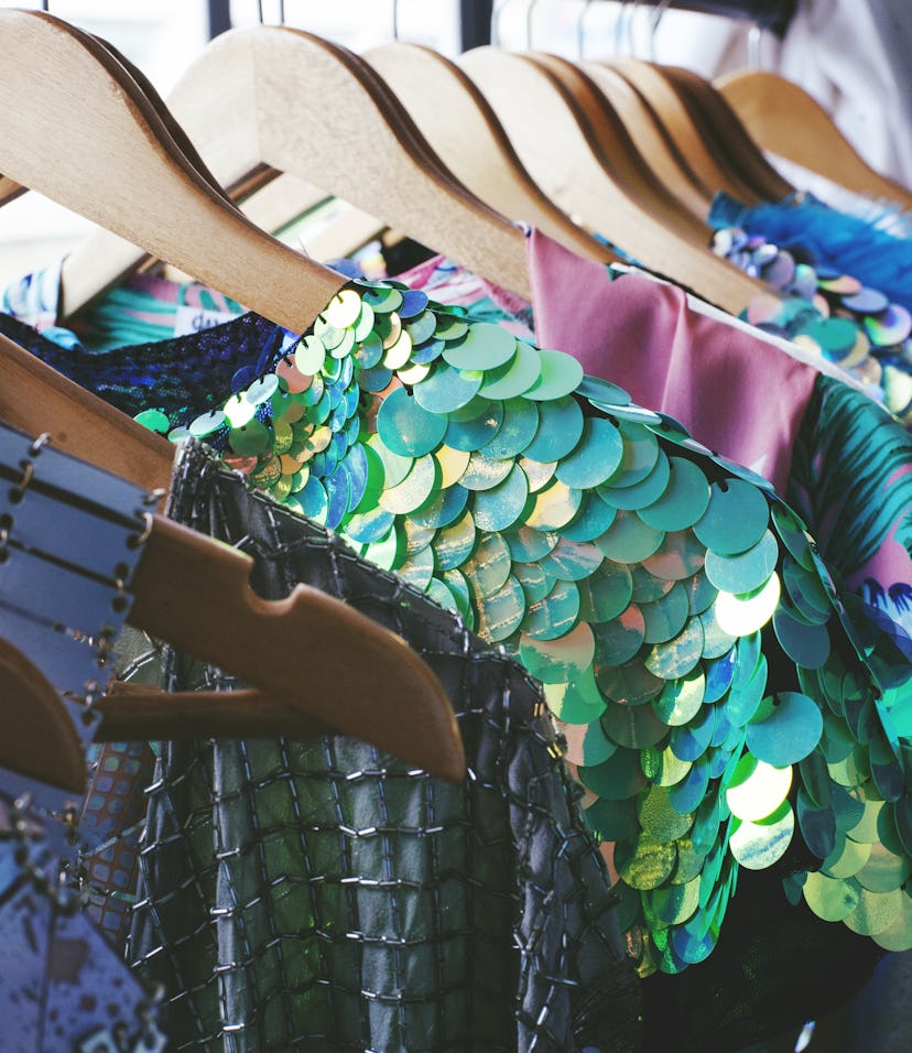 Brightly colored prom dresses, mermaid prom dresses, and sparkly prom dresses on a clothing rack