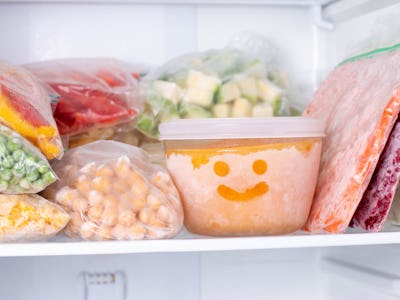 Frozen food in the freezer. Frozen vegetables, soup, ready meals in the freezer